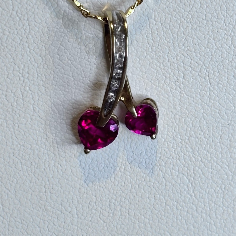 Elegant 10k yellow gold and ruby heart Pendant.